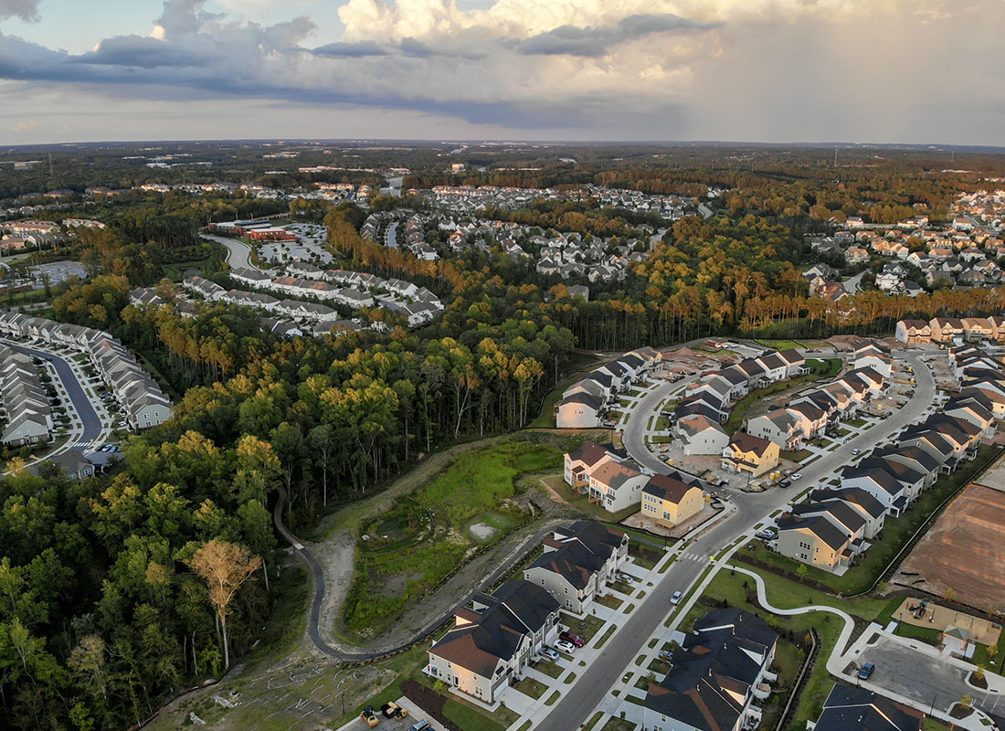 Williamston, NC - Aerial View of a Residential Area Displaying Many Homes and Trees on a Cloudy Day
